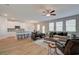 Open-concept living room with abundant natural light, wood flooring, and modern furnishings for comfortable living at 1797 Kingsmere Run Dr, Loganville, GA 30052