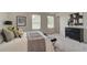 Cozy main bedroom features plush carpeting, two windows, and stylish furniture at 1797 Kingsmere Run Dr, Loganville, GA 30052
