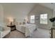 Bright main bedroom with vaulted ceiling, plush carpeting, and two windows at 1797 Kingsmere Run Dr, Loganville, GA 30052