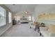 Large main bedroom with sitting area, ceiling fan, and many windows at 1797 Kingsmere Run Dr, Loganville, GA 30052