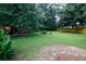 Spacious backyard featuring a large green lawn and a storage shed at 2202 Springdale Dr, Snellville, GA 30078