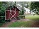 Backyard featuring a shed with white trim and cross brace on the doors at 2202 Springdale Dr, Snellville, GA 30078