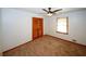 Bedroom featuring carpet, ceiling fan, closet with louvered door, and window at 2202 Springdale Dr, Snellville, GA 30078