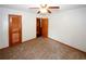 Bedroom featuring carpet, ceiling fan, and two doors at 2202 Springdale Dr, Snellville, GA 30078