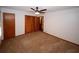 Bedroom features carpet, ceiling fan, closet with louvered doors and window at 2202 Springdale Dr, Snellville, GA 30078