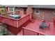 The red deck features dining and lounge areas for relaxing and entertaining at 2202 Springdale Dr, Snellville, GA 30078