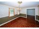 Cozy dining room features hardwood floors, wainscoting, and a vintage chandelier at 2202 Springdale Dr, Snellville, GA 30078