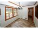 Bright dining room features beautiful wood floors, chandelier, and natural light from large windows at 2202 Springdale Dr, Snellville, GA 30078