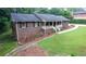A brick home showcasing a well-kept lawn and landscape, complemented by the home's architectural details at 2202 Springdale Dr, Snellville, GA 30078