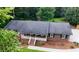 An elevated shot of the beautiful brick home with a well-maintained roof, porch, and landscaping at 2202 Springdale Dr, Snellville, GA 30078