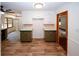 Open-concept kitchen with recessed lighting, wood-look floors, and classic cabinetry at 2202 Springdale Dr, Snellville, GA 30078