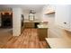 Bright kitchen with stainless steel appliances and view into living room with dark brick fireplace at 2202 Springdale Dr, Snellville, GA 30078