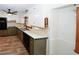 Bright kitchen featuring white cabinets and countertops, a black faucet and appliances, and wood-look flooring at 2202 Springdale Dr, Snellville, GA 30078