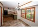 Bright kitchen with a vintage chandelier and a window showing some foliage in an outdoor space at 2202 Springdale Dr, Snellville, GA 30078