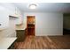 Bright kitchen featuring wood-look flooring, ample white cabinetry, and a neutral countertop at 2202 Springdale Dr, Snellville, GA 30078