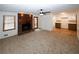 Spacious carpeted living room featuring a brick fireplace, and seamless transition to the kitchen area at 2202 Springdale Dr, Snellville, GA 30078