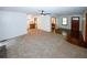 Spacious living room with plush carpeting, ceiling fan, and natural light streaming in through the windows at 2202 Springdale Dr, Snellville, GA 30078