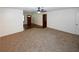 Spacious carpeted living room with plenty of natural light, fresh white walls and ceiling fan at 2202 Springdale Dr, Snellville, GA 30078