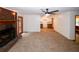 Spacious carpeted living room featuring a brick fireplace and a seamless transition to the kitchen area at 2202 Springdale Dr, Snellville, GA 30078