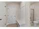 Welcoming mudroom featuring a built-in bench, coat hooks, and convenient access to a nearby bathroom at 722 Crossroad Ct, Powder Springs, GA 30127