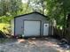 Backyard shed with a roll-up door and a separate entrance, ideal for storage and hobbies at 1482 Whitfield Se St, Smyrna, GA 30080