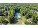 Aerial view of the community pool and tennis courts in neighborhood with mature tree coverage at 1655 Oak Crest Ct, Marietta, GA 30066