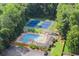 Aerial view featuring a community pool, tennis courts, green space and shaded lounge area at 1655 Oak Crest Ct, Marietta, GA 30066