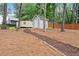 View of backyard with mulched path leading to the storage shed and detached structure at 1655 Oak Crest Ct, Marietta, GA 30066