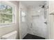 Updated bathroom showcasing modern tile shower with a glass enclosure and hexagon-shaped tile floor at 1655 Oak Crest Ct, Marietta, GA 30066