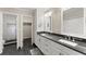 Bright bathroom with dual sinks, granite countertop, and a tiled shower in the background at 1655 Oak Crest Ct, Marietta, GA 30066