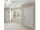 Bright bedroom showcasing neutral walls, carpeting, and large windows that let in natural light at 1655 Oak Crest Ct, Marietta, GA 30066