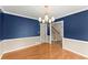Dining room showcasing hardwood flooring, elegant chandelier, and view of the entry at 1655 Oak Crest Ct, Marietta, GA 30066