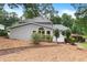 Exterior view of the home featuring large windows, beautiful landscaping and a bench seat at 1655 Oak Crest Ct, Marietta, GA 30066