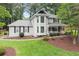 View of the exterior showcasing its manicured lawn and mature landscaping around the foundation at 1655 Oak Crest Ct, Marietta, GA 30066