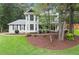 Charming two-story home with landscaped yard and inviting front porch nestled among mature trees at 1655 Oak Crest Ct, Marietta, GA 30066