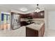 Updated kitchen with stainless steel appliances, dark cabinets, and tiled floor at 1655 Oak Crest Ct, Marietta, GA 30066