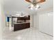 Spacious kitchen featuring a ceiling fan, dark cabinets, and white tiled floors at 1655 Oak Crest Ct, Marietta, GA 30066