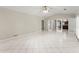 Spacious living room with white tile floor, ceiling fan, and direct access to the kitchen at 1655 Oak Crest Ct, Marietta, GA 30066
