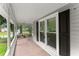 Relaxing covered porch with brick flooring and a swing, perfect for enjoying the outdoors at 1655 Oak Crest Ct, Marietta, GA 30066