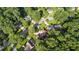Aerial view of the home nestled among lush green trees and landscaping at 2050 Trotters Ridge Way, Roswell, GA 30075