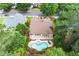 An aerial view of a backyard pool with a patio and lounge seating at 1065 Beacon Hill Xing, Alpharetta, GA 30005