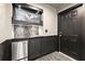 Finished basement wet bar featuring a stainless steel refrigerator and door to exterior at 1065 Beacon Hill Xing, Alpharetta, GA 30005