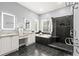 Contemporary bathroom featuring dual sinks, granite countertops, and a luxurious glass shower with black brick at 1065 Beacon Hill Xing, Alpharetta, GA 30005