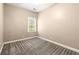 Carpeted bedroom with a bright window, and neutral wall paint provides a clean, adaptable space at 1065 Beacon Hill Xing, Alpharetta, GA 30005