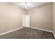 Neutral bedroom with carpet flooring, ceiling fan, and entry door at 1065 Beacon Hill Xing, Alpharetta, GA 30005