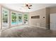 Spacious bedroom with a ceiling fan, large windows offering a view of the pool, and plush carpeting at 1065 Beacon Hill Xing, Alpharetta, GA 30005