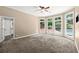 Bedroom featuring a neutral color palette, plush carpeting, and large windows offering views of the backyard pool at 1065 Beacon Hill Xing, Alpharetta, GA 30005