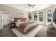 Bedroom with ceiling fan and many windows, providing excellent natural light and views of the backyard pool at 1065 Beacon Hill Xing, Alpharetta, GA 30005