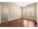 Bright bedroom with hardwood floors, natural light, and a view into another room at 1065 Beacon Hill Xing, Alpharetta, GA 30005