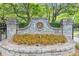 Stone sign and manicured landscaping at The Golf Club of Georgia community entrance at 1065 Beacon Hill Xing, Alpharetta, GA 30005